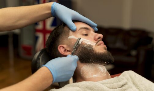 barber-shaving-contouring-male-customer-s-beard